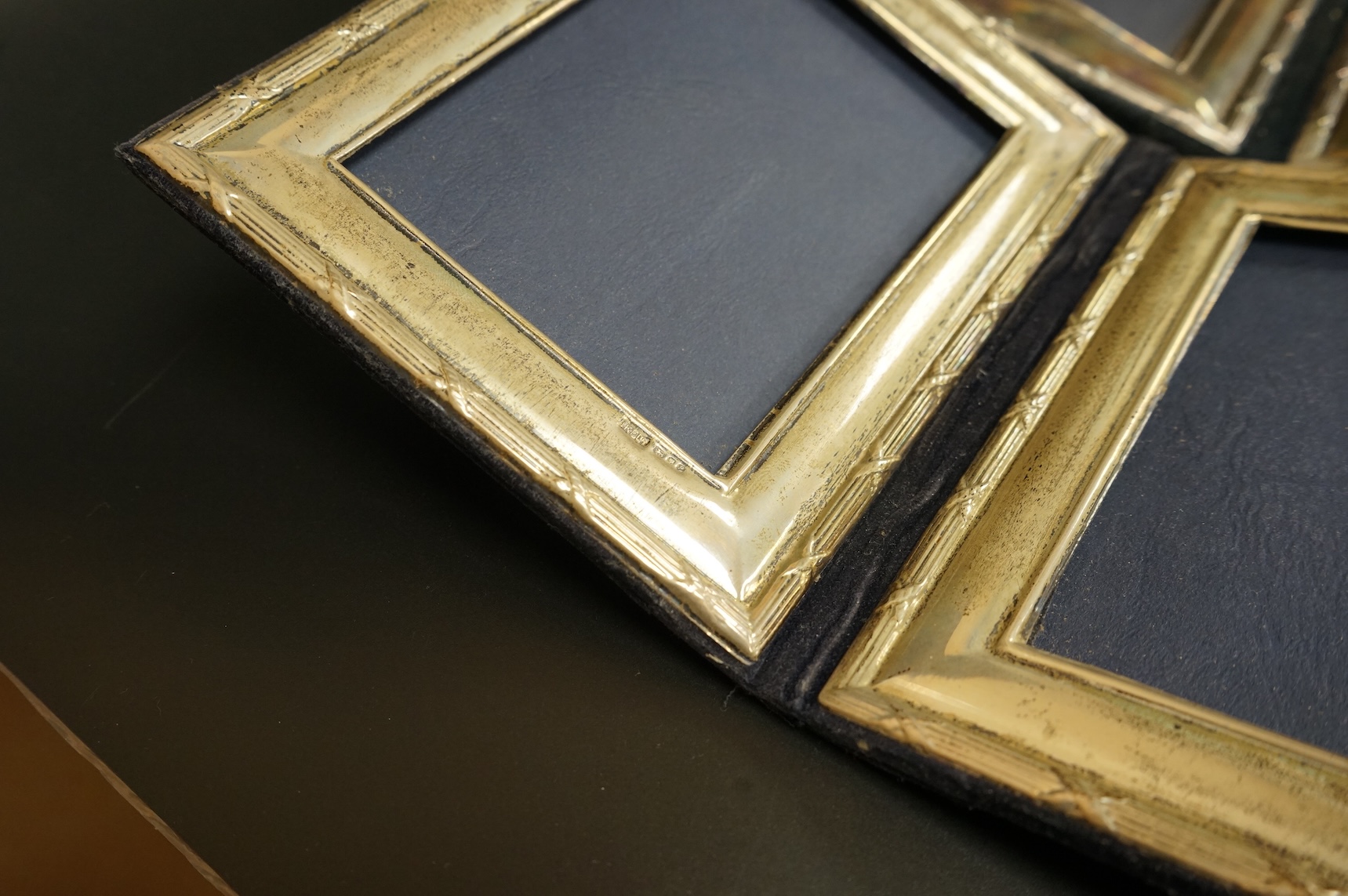 A late Victorian repousse silver mounted rectangular photograph frame, Birmingham, 1898, 17.9cm, a smaller Edwardian silver mounted photograph frame, Williams Ltd, Birmingham, 1905 and a set of four modern silver mounted